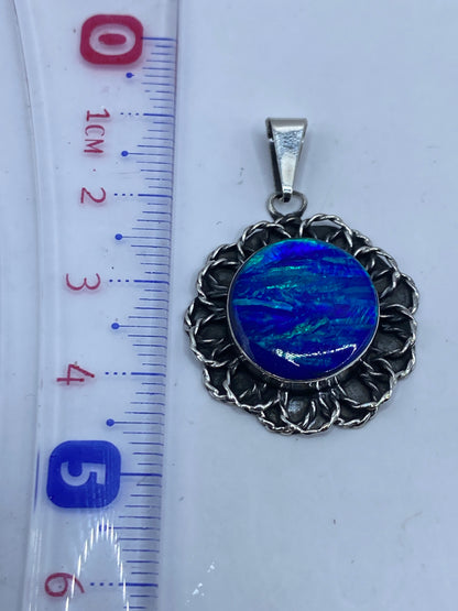 Reverso del dije en plata, mostrando el Quinto .925 grabado, sobre fondo neutro