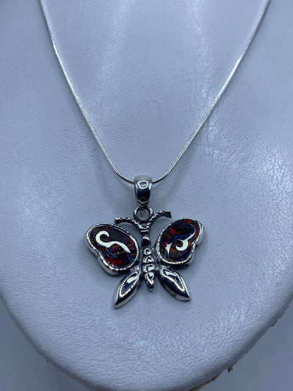 Dije de mariposa en plata .950 sobre fondo blanco, mostrando el Quinto 950