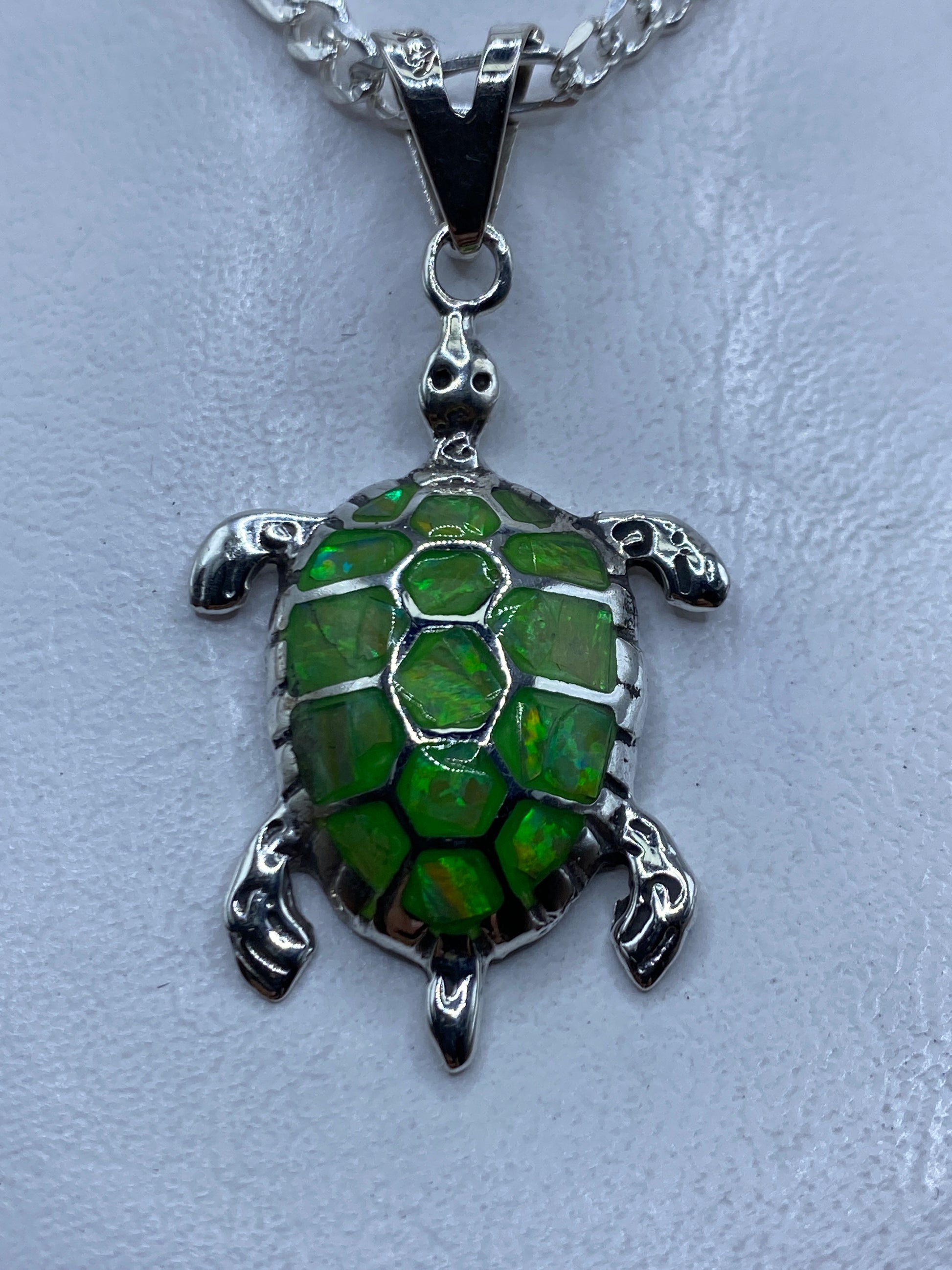 Dije de tortuga en plata .950 con ópalo de fuego verde limón, colgado de una cadena Figaro