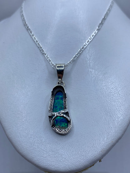 Dije de 4.4 cm sobre cadena de plata, mostrando el color azul profundo del ópalo