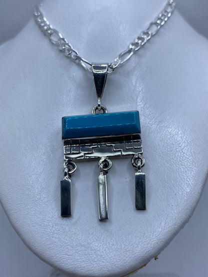 Detalle de la turquesa azul natural incrustada en plata, mostrando el trabajo a mano
