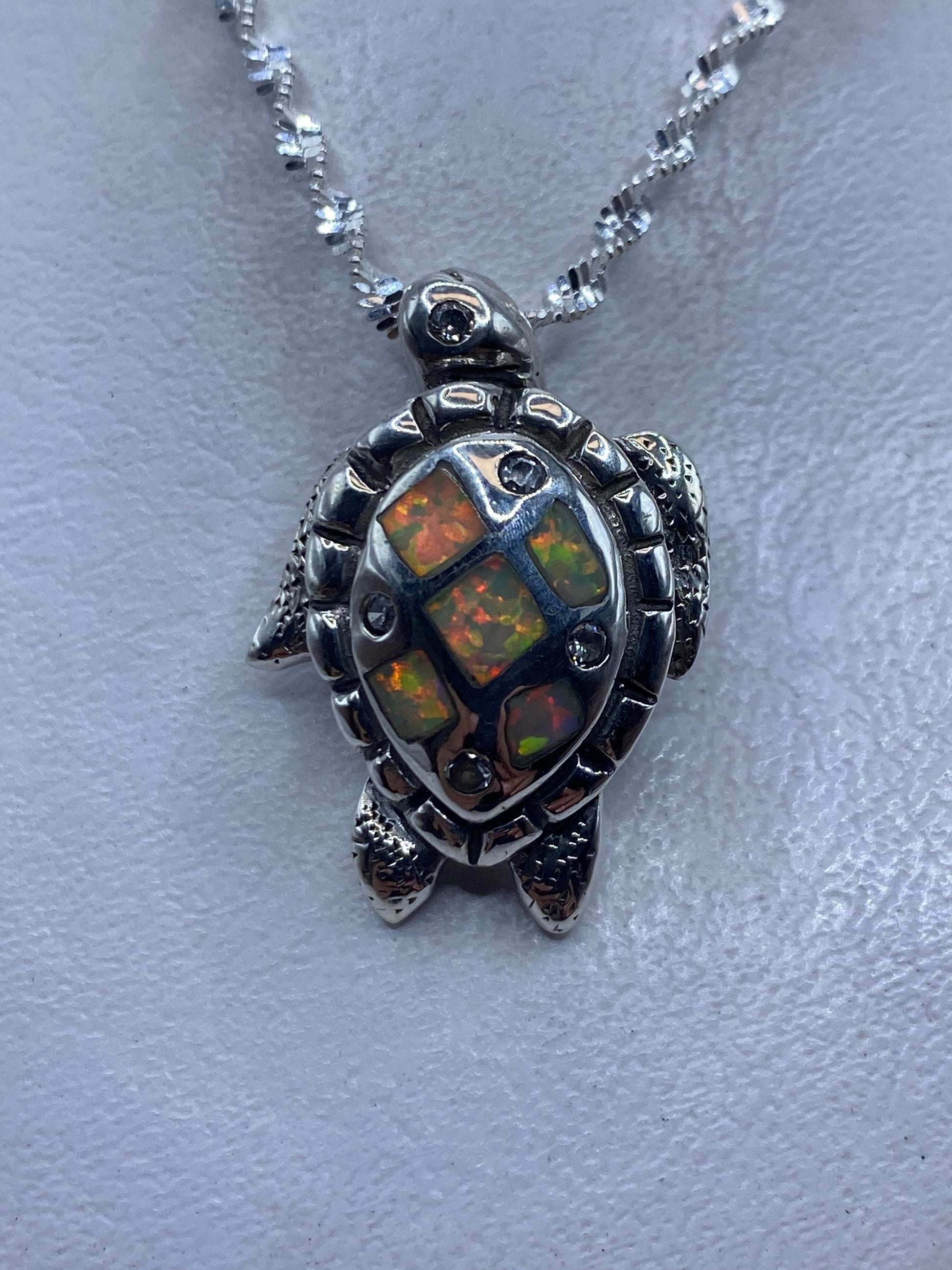 Dije tortuga de plata .925 con ópalo de fuego multicolor en cadena de plata