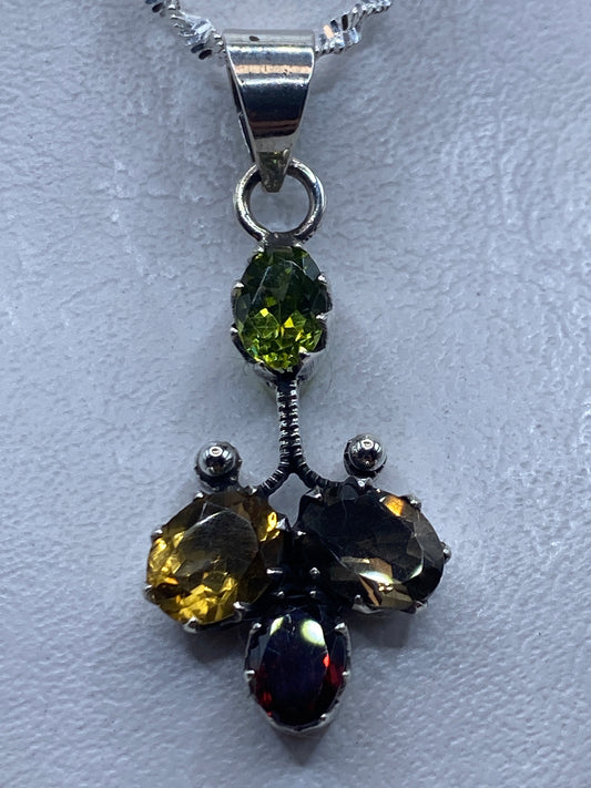 Dije de plata 4.9 cm con circonia multicolor amarilla, negra y roja engastado a mano, colgado en cadena de plata