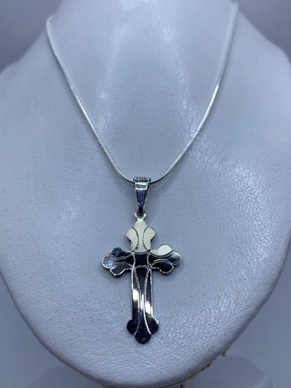 Cruz de plata fundida mostrando el acabado brillante y detalles texturizados