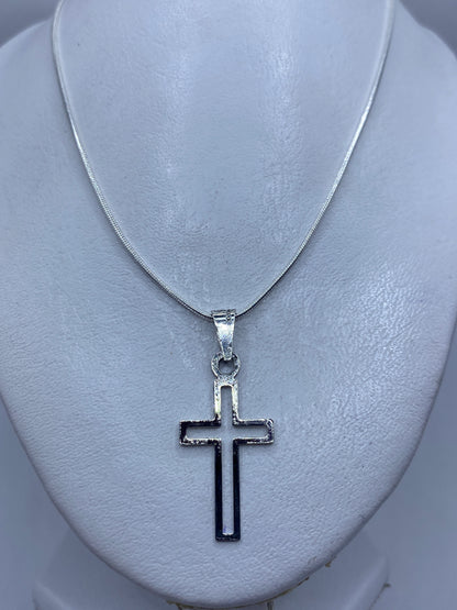 Cruz de plata .925 colgada sobre el pecho, tamaño discreto