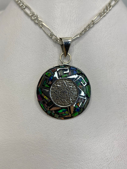 Detalle frontal del dije mostrando el ópalo de fuego y el engaste artesanal de plata