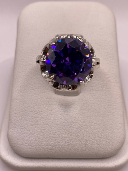Anillo solitario de plata .925 con circonia redonda color violeta intenso en engaste de garras ornamentadas, vista cenital
