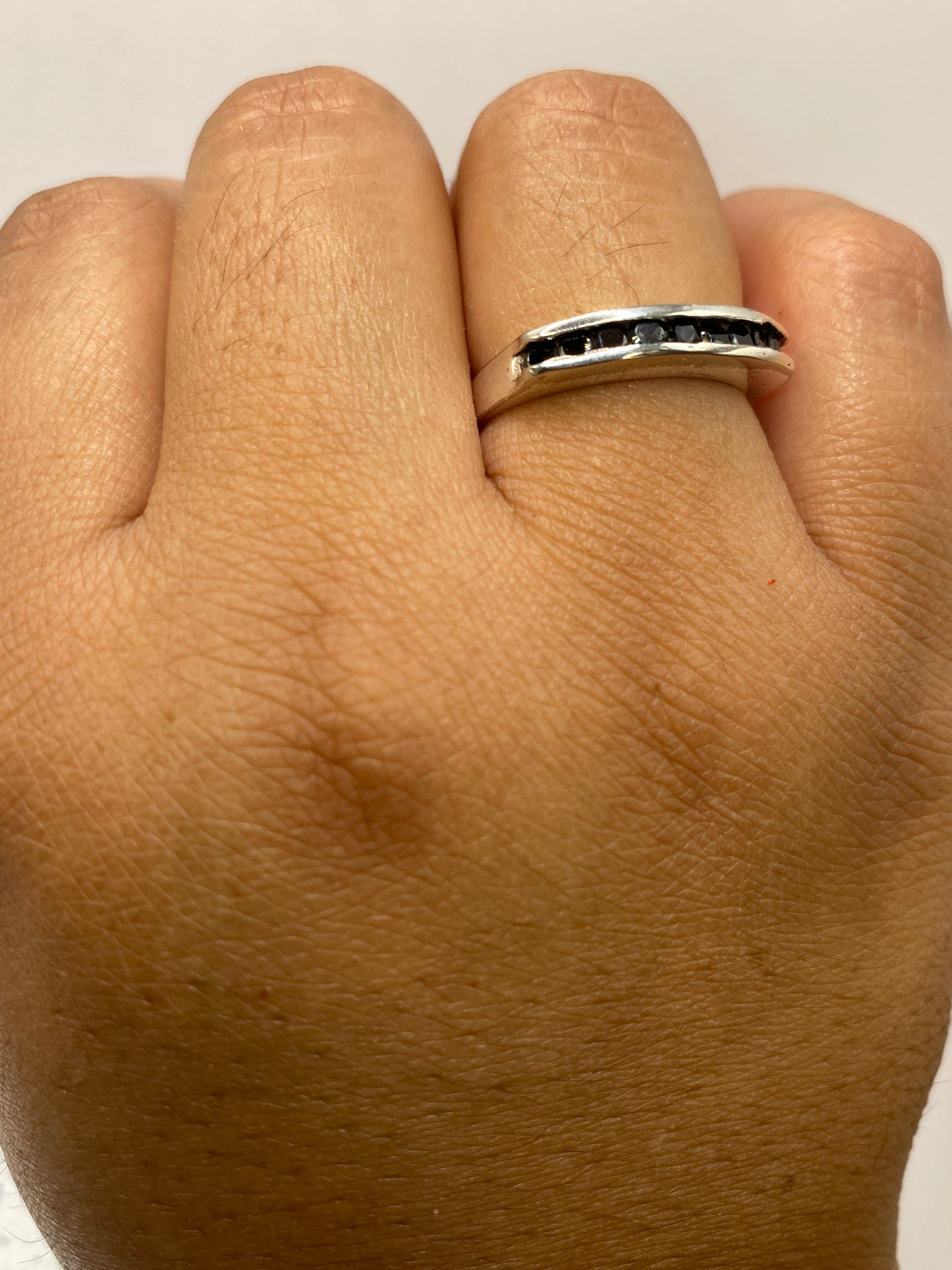 Anillo sobre fondo blanco mostrando el sello 925 y la construcción artesanal del engaste