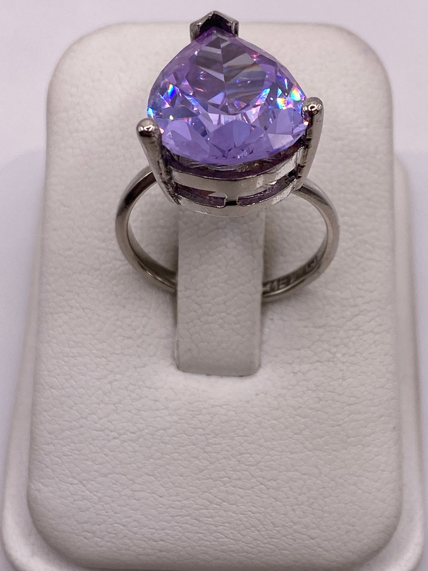 Anillo de plata ajustable con circonia morada facetada en posición frontal