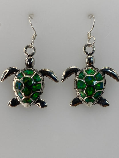 Aretes de lado, con medida en escala milimétrica — 3.3 cm de largo
