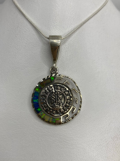 Dije de plata 950 con calendario azteca y ópalo de fuego multicolor colgado de cadena de serpentina