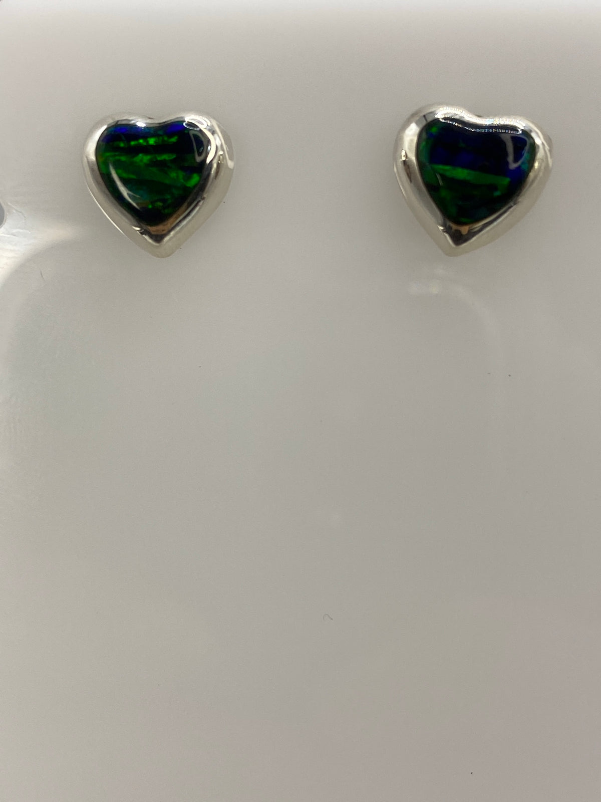 Par de aretes de plata con ópalo de fuego verde engastado, colgando de pernos de presión