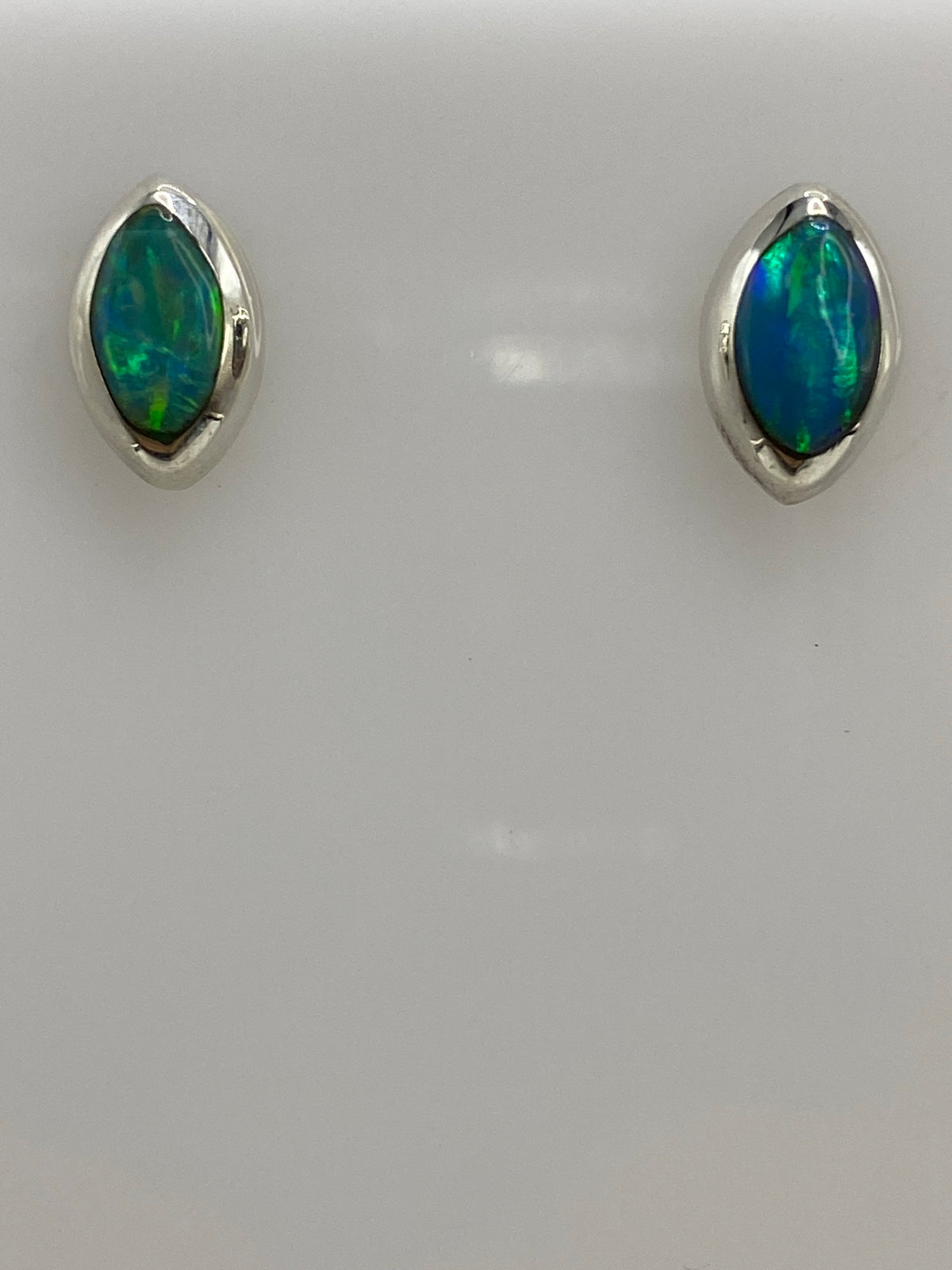 Pair of earrings with Quinto 925 hallmark visible on silver post