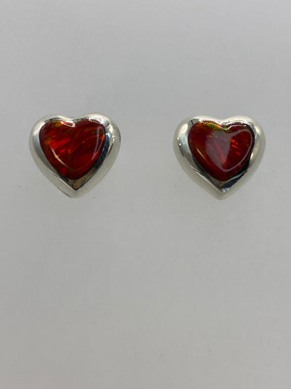 Detalle frontal de los aretes mostrando el tono rojo intenso del Ópalo de Fuego