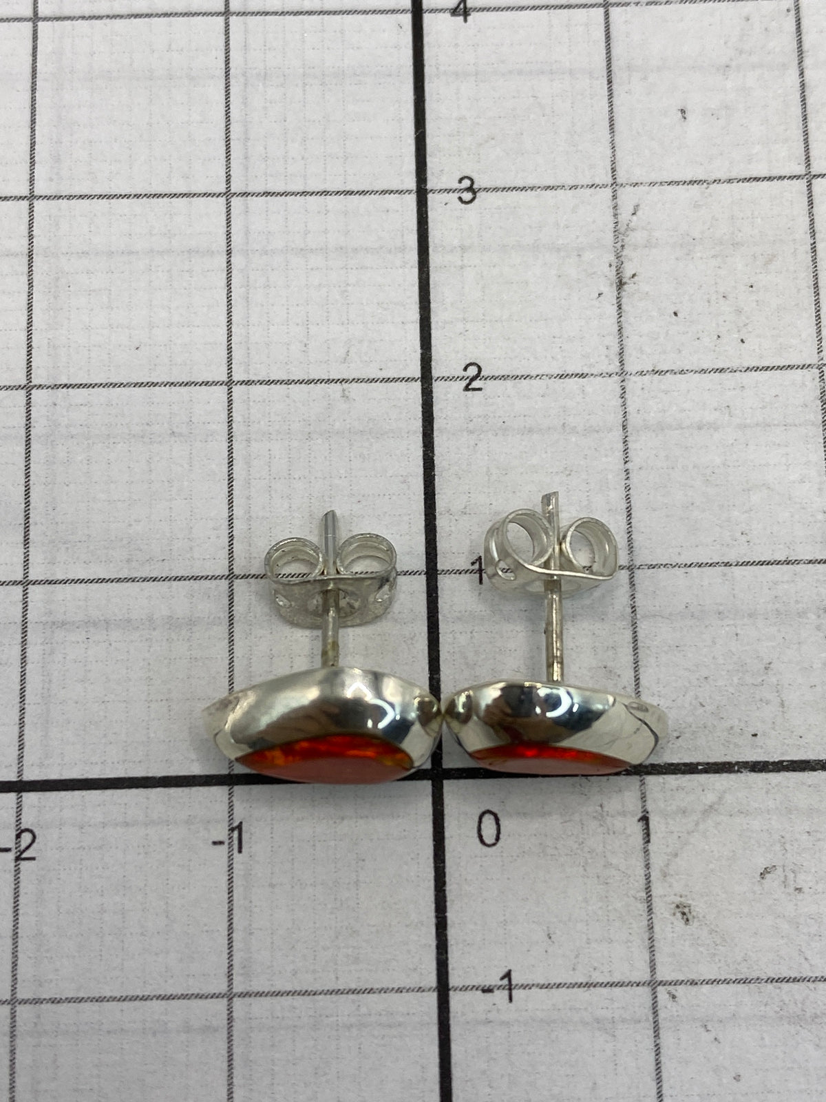 Aretes con opalo de fuego mostrando los reflejos dorados de la piedra