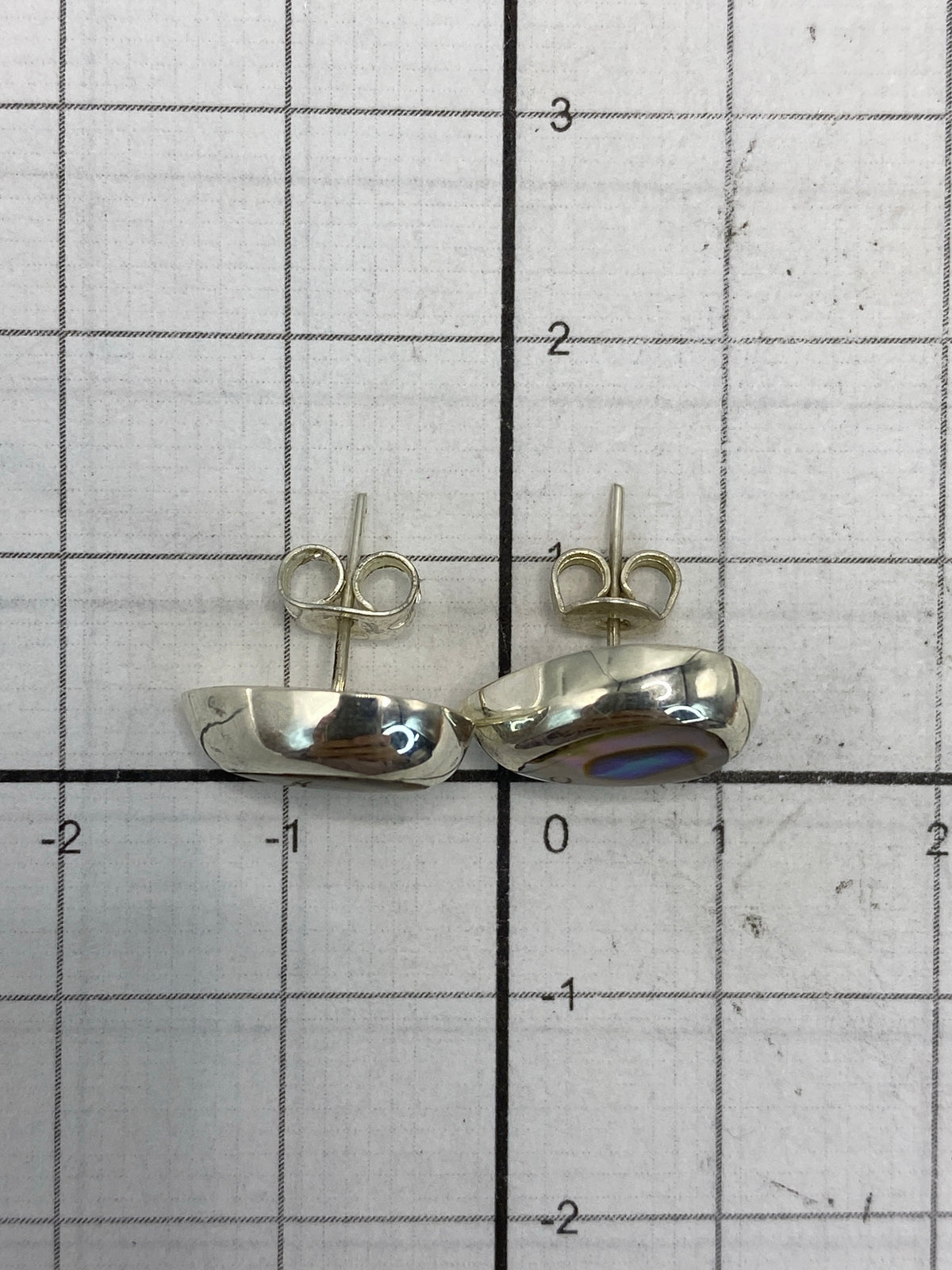 Pair of sterling silver earrings with multicolor stone on white background