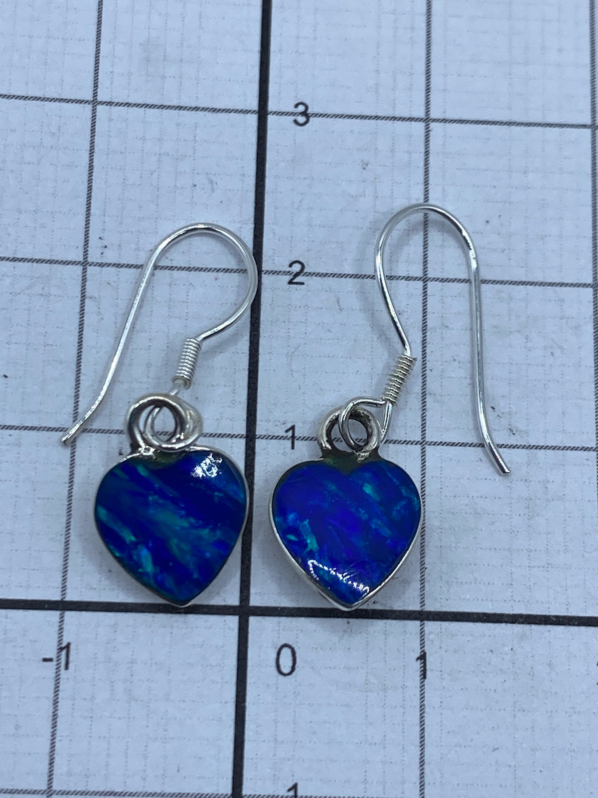 Medicion del largo de los aretes: 2.3 cm en regla metricas, par completo visible