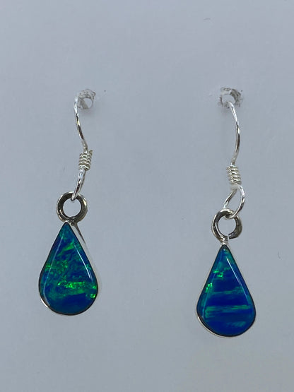 Par de aretes de plata con ópalo de fuego multicolor, luz verde y azul brillando