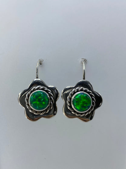 Detalle del engaste a mano del ópalo de fuego y los pétalos de plata