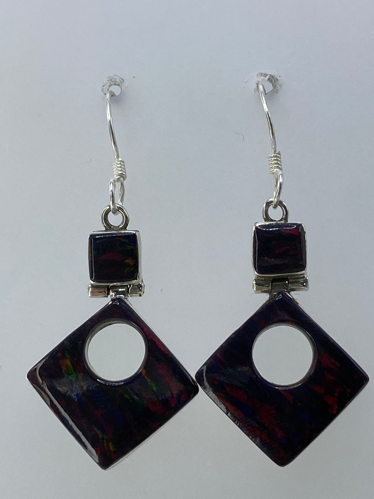 Aretes de plata con ópalo de fuego multicolor en forma de cuadrado, colgando del oído