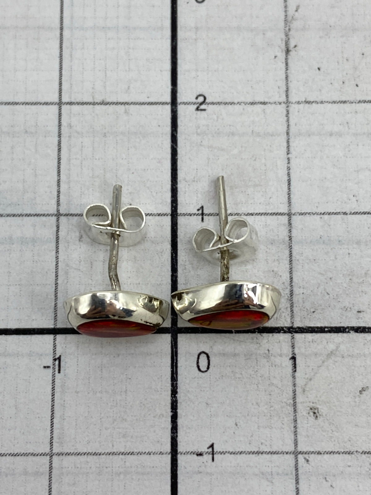 Reverso de los aretes en poste plateado, marcando la autenticidad 925