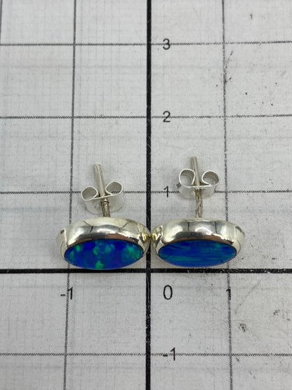 Reverso de los aretes mostrando el Quinto 925 grabado en plata
