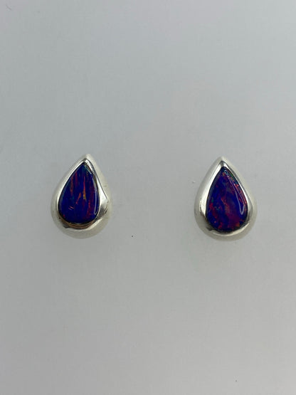 Detalle del ópalo de fuego morado engastado en plata, mostrando los reflejos profundos de la piedra
