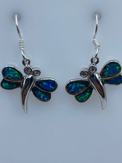 Aretes sobre fondo blanco mostrando el brillo azul del Ópalo