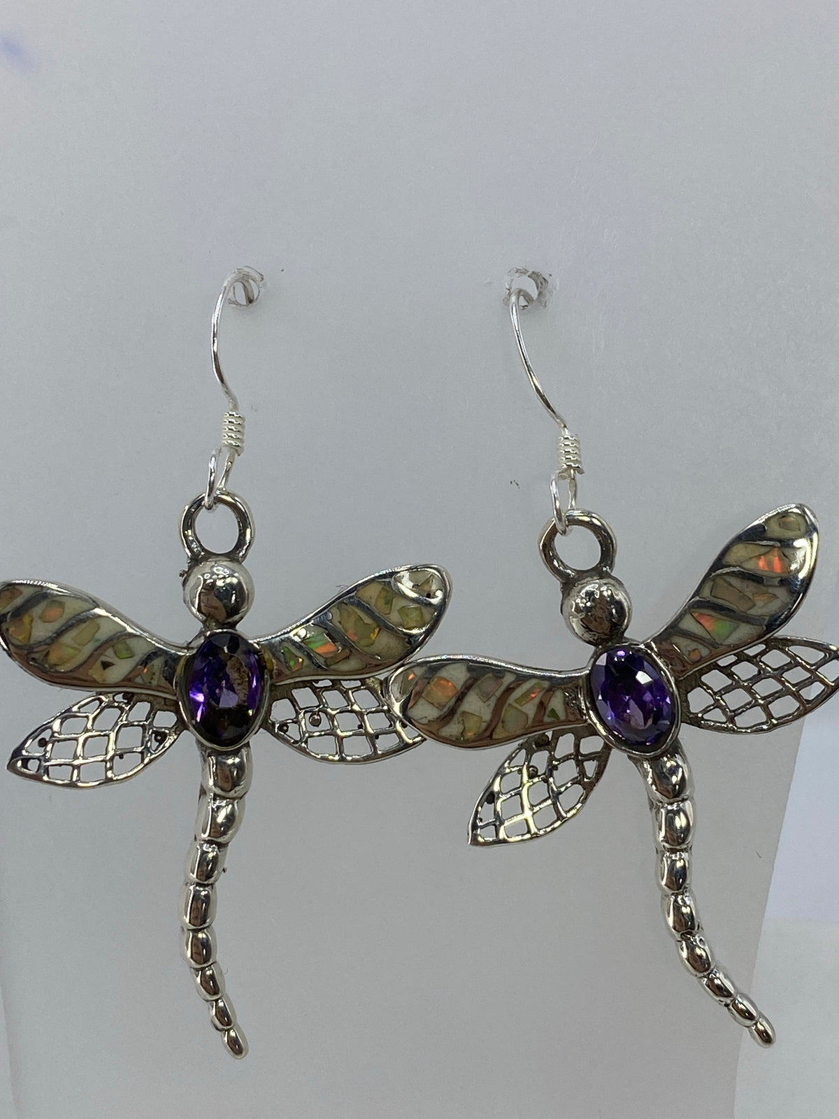 Par de aretes de plata con ópalo de fuego multicolor colgando de ganchos de plata