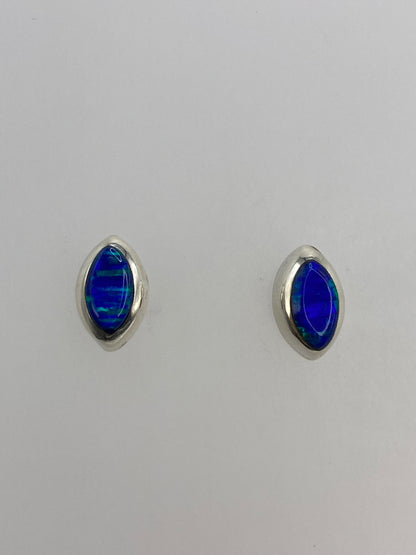 Par de aretes de plata con opalo de fuego azul, vista frontal mostrando la piedra engastada
