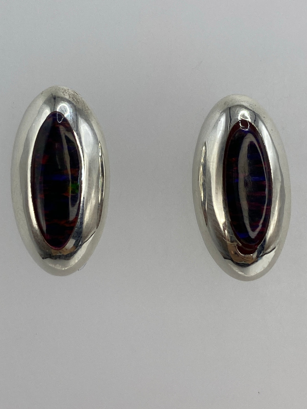 Aretes sobre regla milimetrada mostrando medidas 1.3 × 1.9 cm