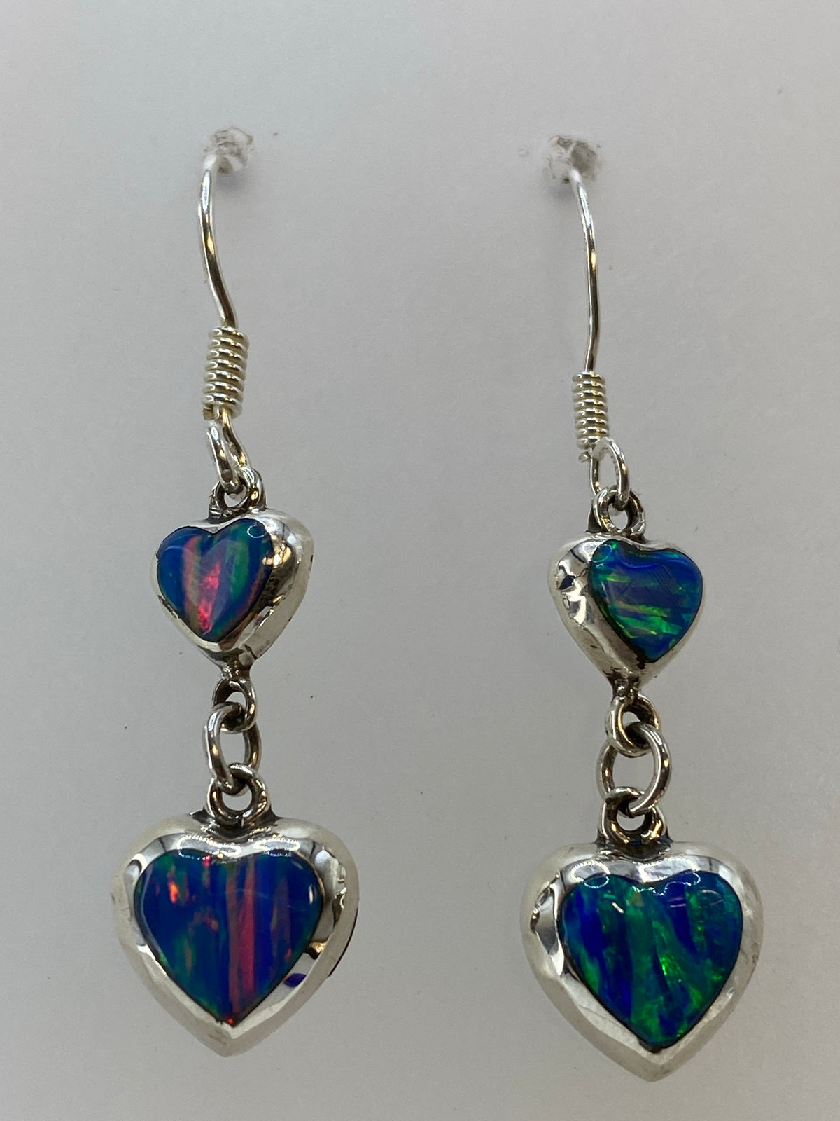 Pair of earrings showing iridescent fire opal in red, green, and blue tones