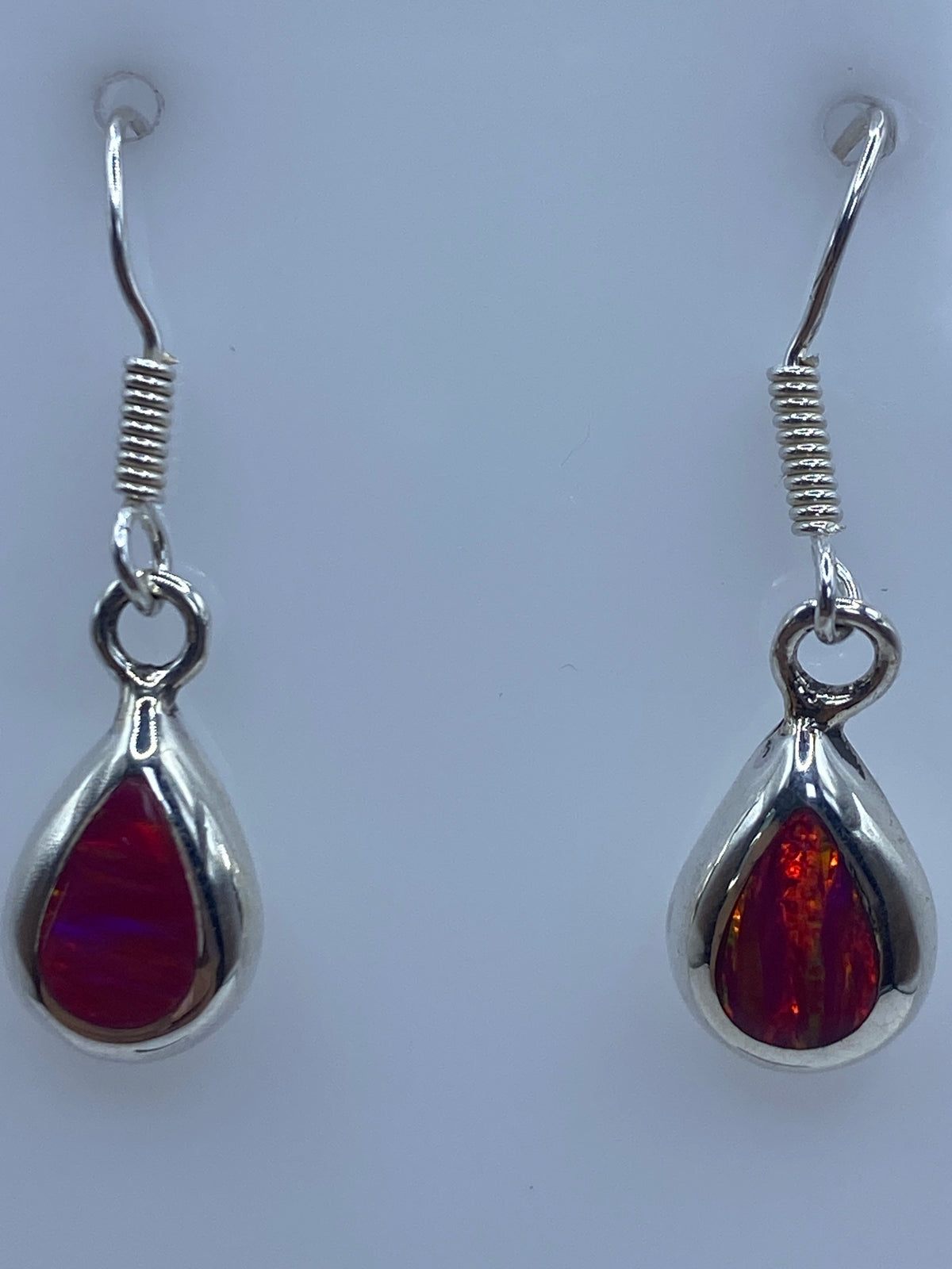 Los dos aretes juntos sobre regla métrica indicando 2.9 cm de largo
