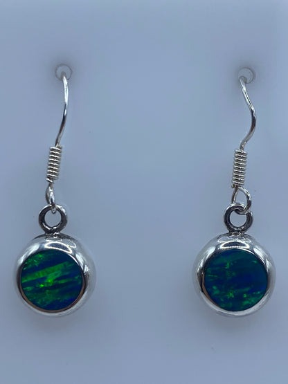 Par de aretes de plata con ópalo de fuego azul en vista frontal