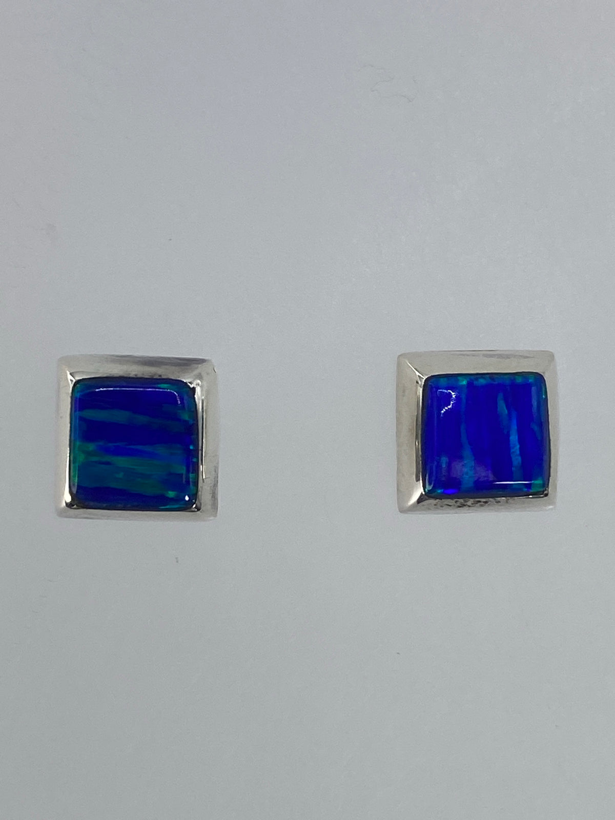 Par de aretes de plata con circonia verde limón engastada, sobre fondo blanco