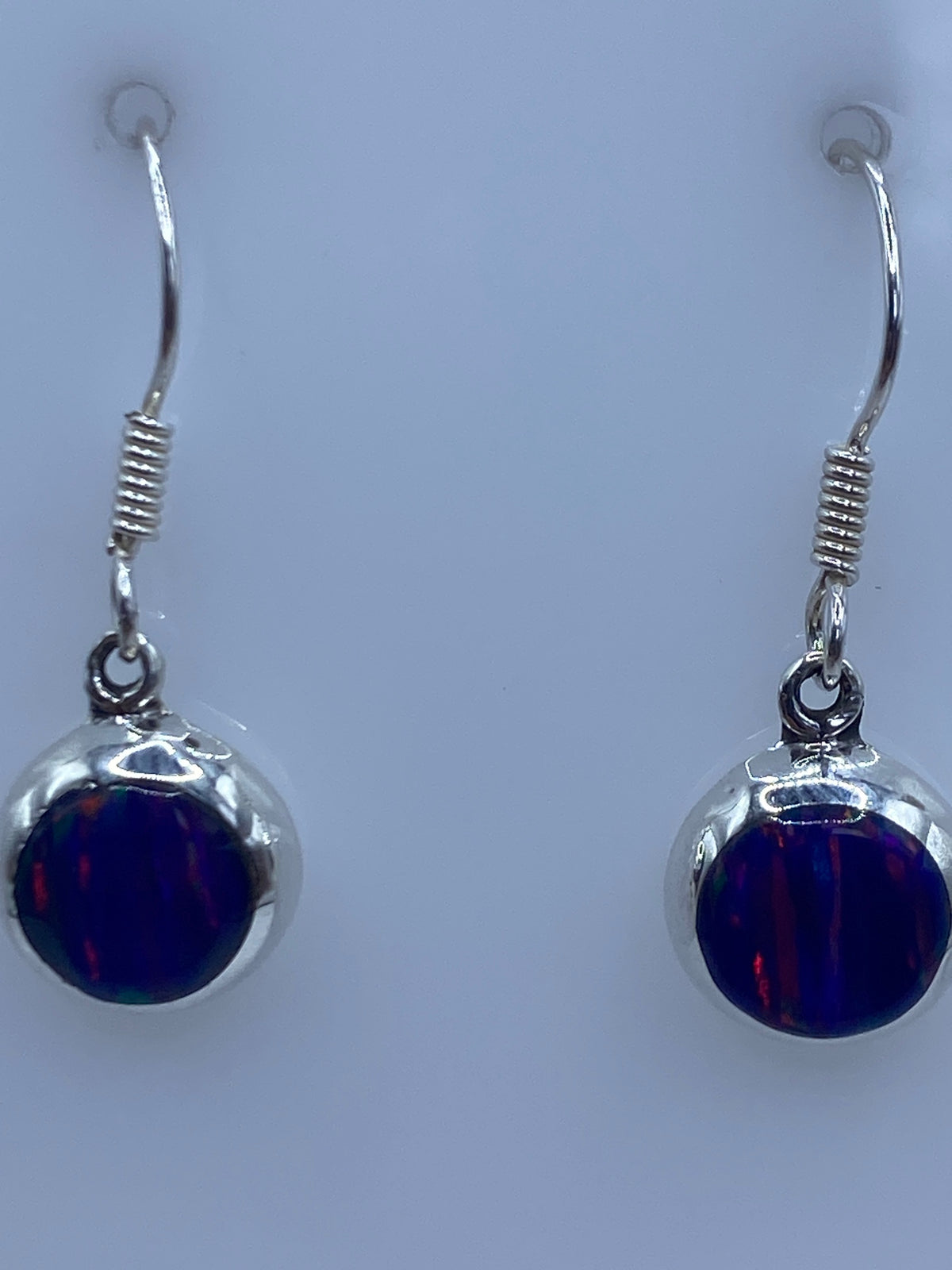 Aretes sobre regla de centímetros mostrando largo de 2.7 cm