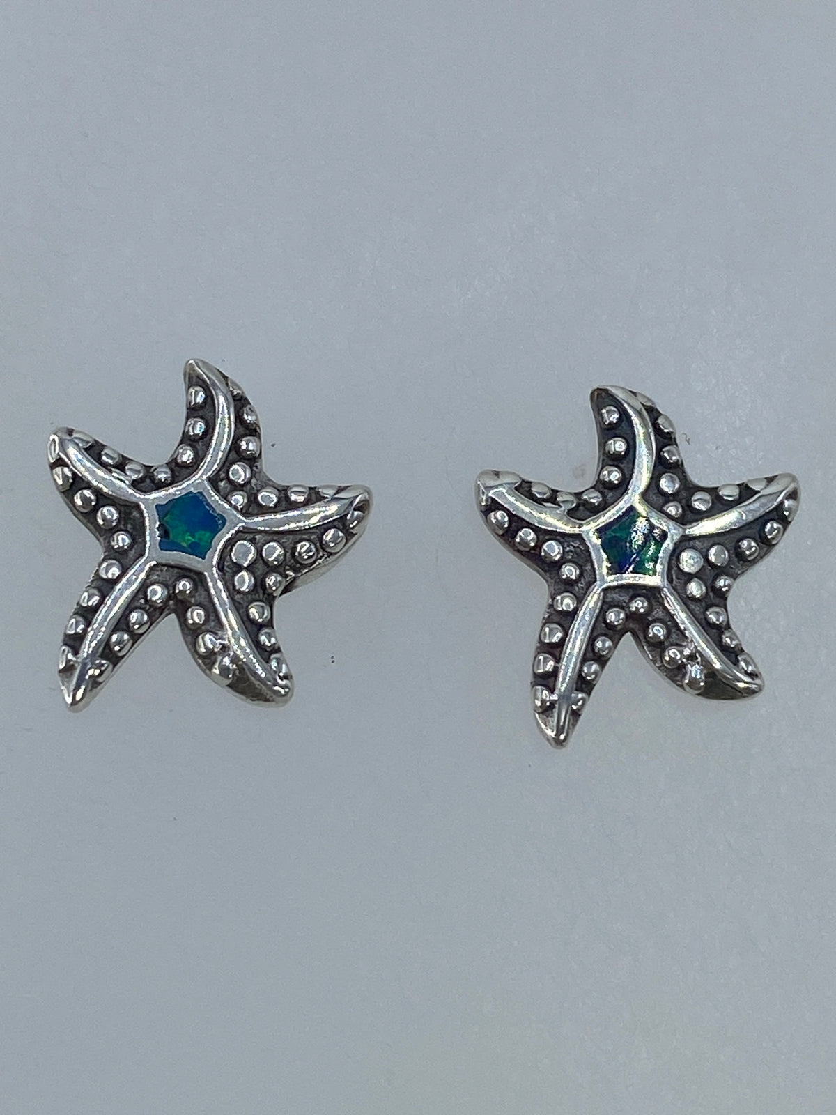 Aretes de plata de Taxco 925 con piedra Ópalo de Fuego, detalle del engaste a mano