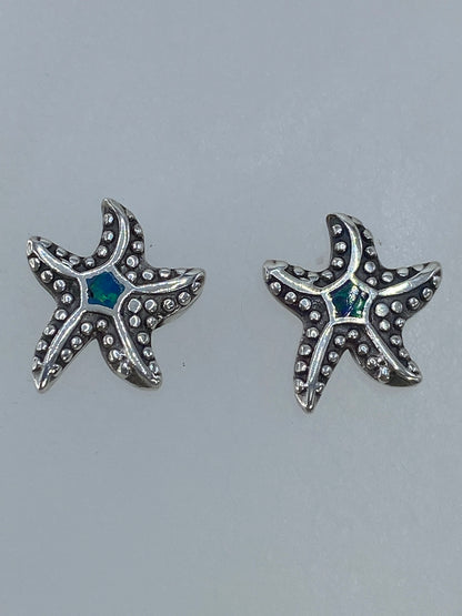 Aretes de plata de Taxco 925 con piedra Ópalo de Fuego, detalle del engaste a mano