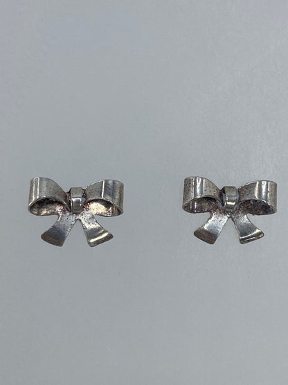 Aretes de moño de plata con cierre de poste, vista frontal