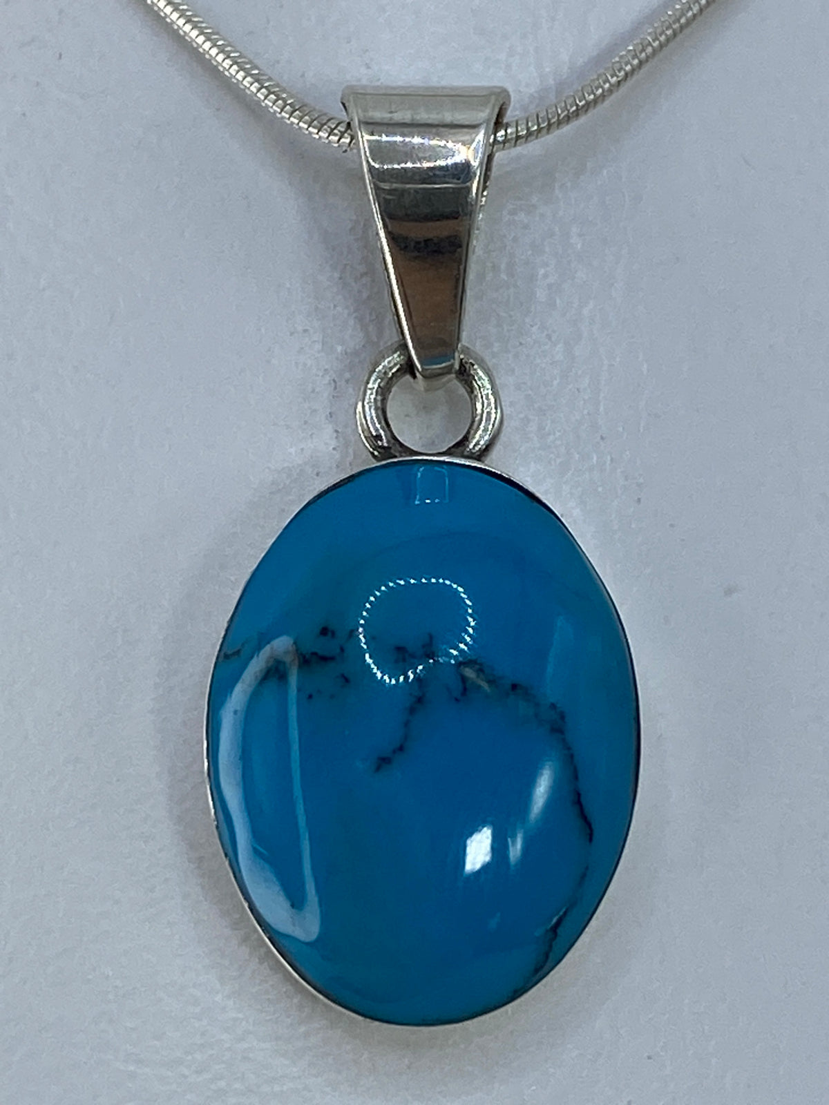 Detalle del engaste de turquesa natural en plata pulida