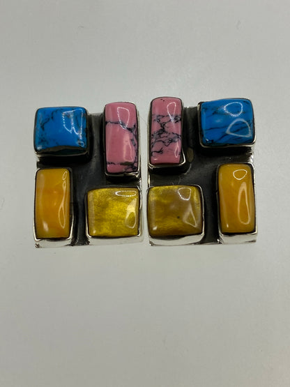 Detalle del engaste de turquesa en tonos azul, rosa y amarillo en los aretes