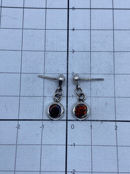 Reverso de aretes mostrando marcas de Quinto 925 en los postes de plata