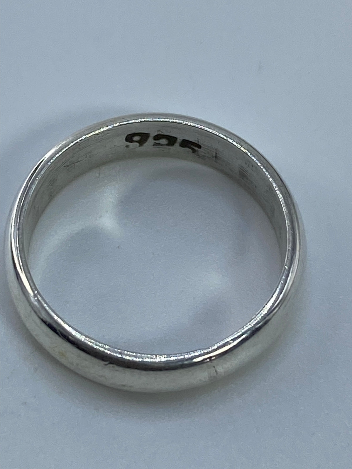 Anillo puesto en el dedo, mostrando la banda lisa y brillante en uso