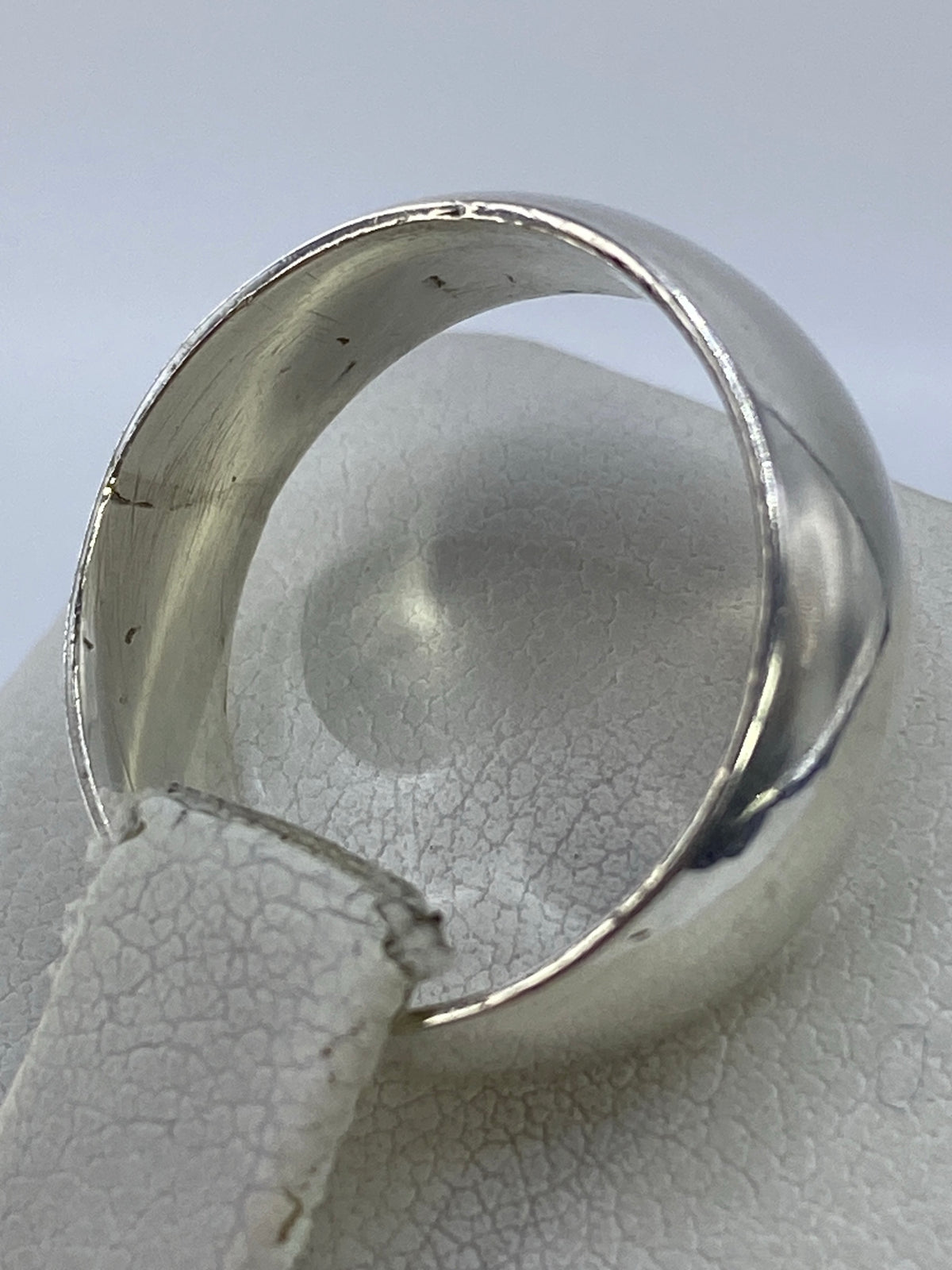 Anillo de plata 925 puesto en la mano, mostrando el brillo uniforme