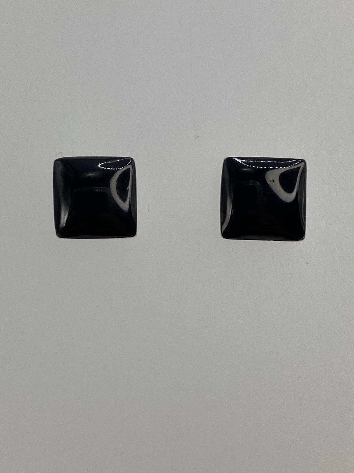 Aretes sobre paño azul con escala de gramos mostrando peso de 1.81 g el par