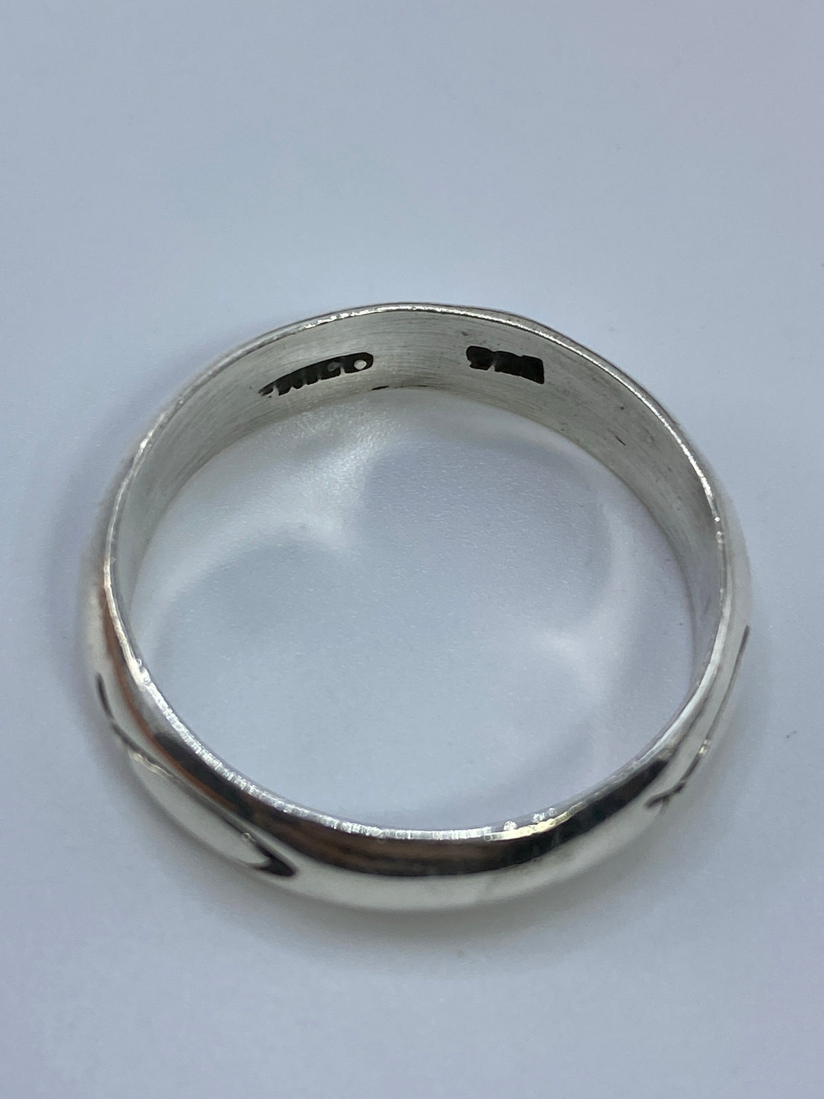 Anillo sobre fondo blanco mostrando el contraste y reflejo del pulido