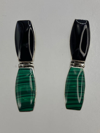 Detalle cercano de la incrustación de ónix negro y malaquita verde en plata 950