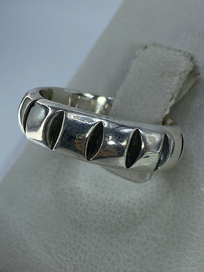 Anillo en plata Taxco con detalles en relieve colocado en mano mostrando el acabado pulido