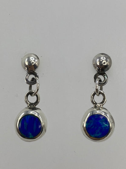 Aretes sobre paño blanco con medidor de escala, 2 cm de largo