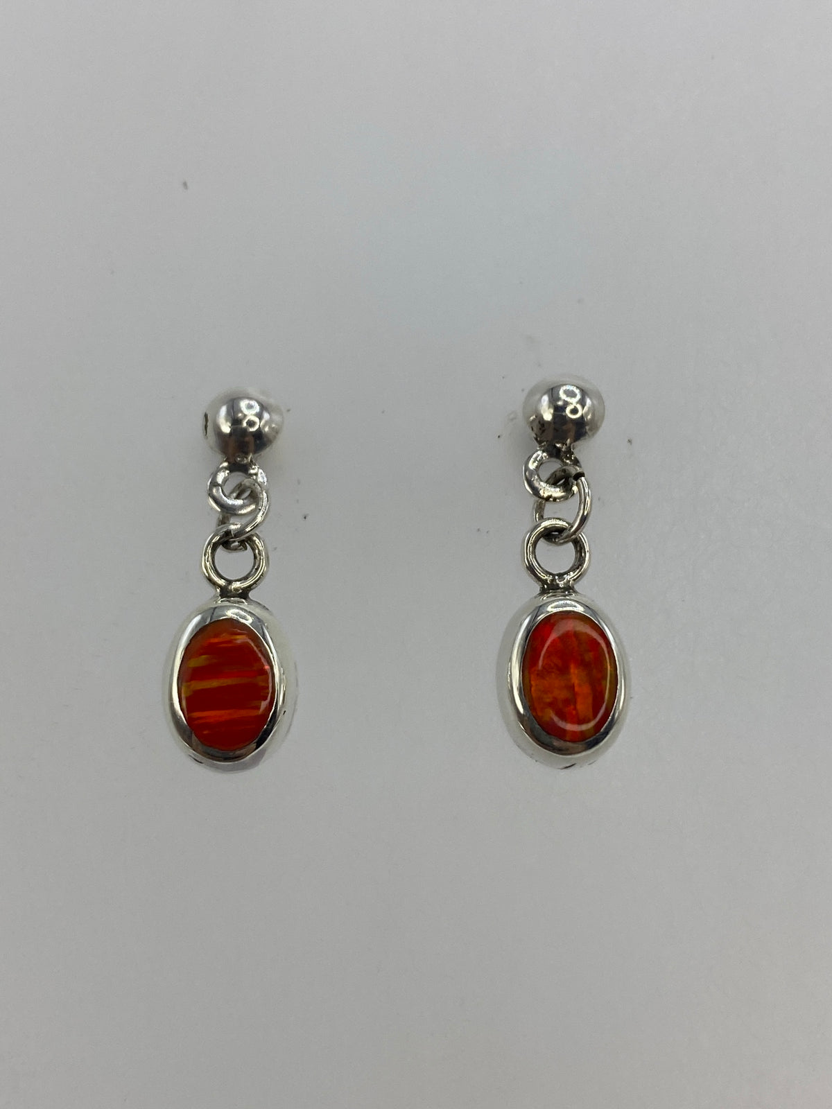 Close-up detail of the orange fire opal stone in sterling silver setting